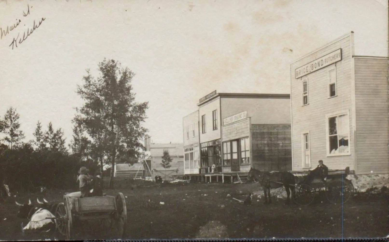 Main Street, Kelliher, with early wooden stores and wagons