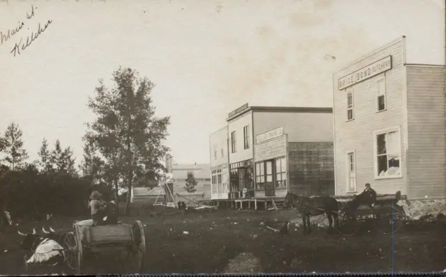 Main Street, Kelliher, with early wooden stores and wagons